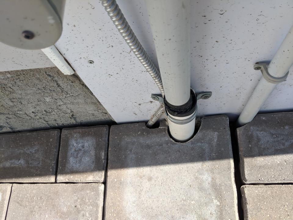 bricks cut to fit around pipes